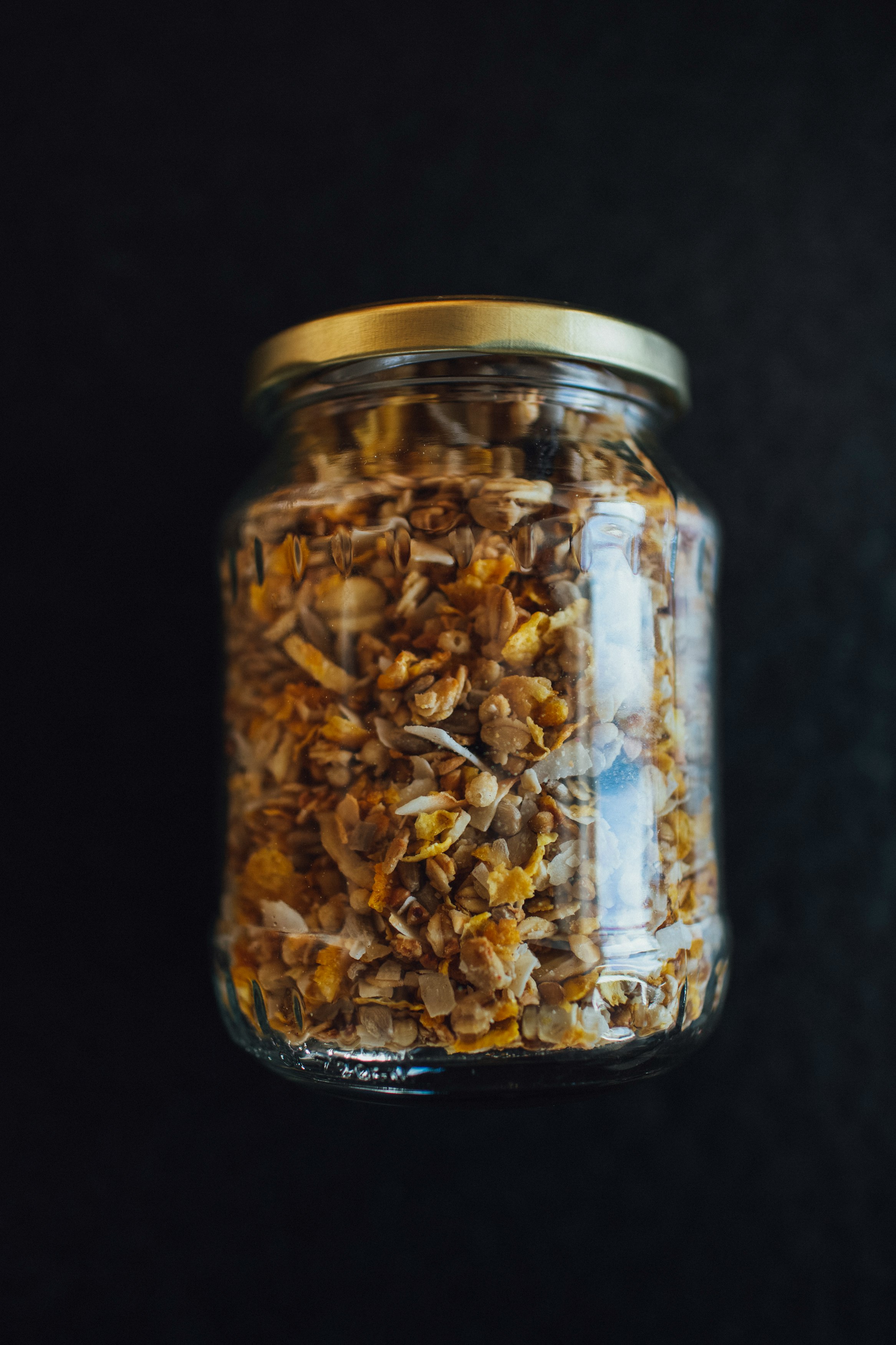 brown and black beads in clear glass jar